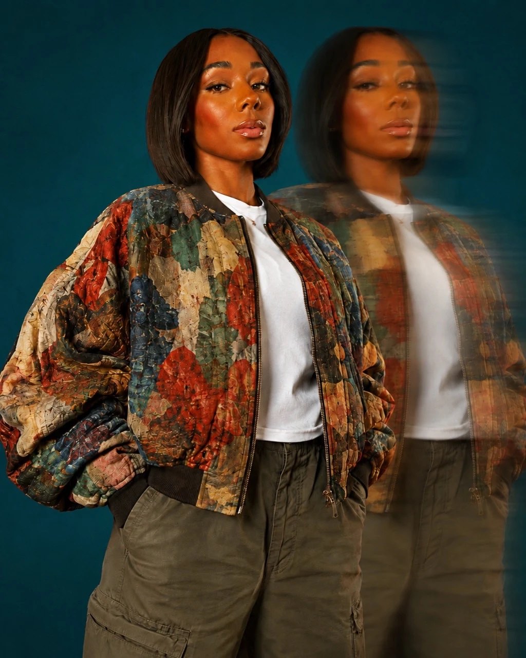 Nyla Robinson wearing a floral jacket against a teal backdrop
